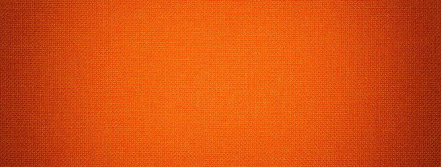 Bright orange background from textile material with wicker pattern and vignette. Structure of ginger fabric