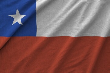 Fototapeta premium Chile flag depicted on folded wavy fabric of old cloth close up