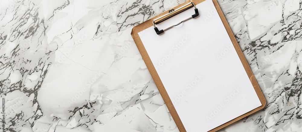 Poster a clipboard with a blank white sheet providing copy space image with selective focus
