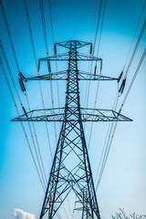High-Voltage Transmission Tower Against Clear Blue Sky Illustrating Electrical Power Distribution
