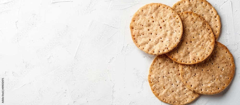 Poster Circular diet crispbreads on a white backdrop Circular whole grain crackers yeast free healthy option Ideal for text copy space image