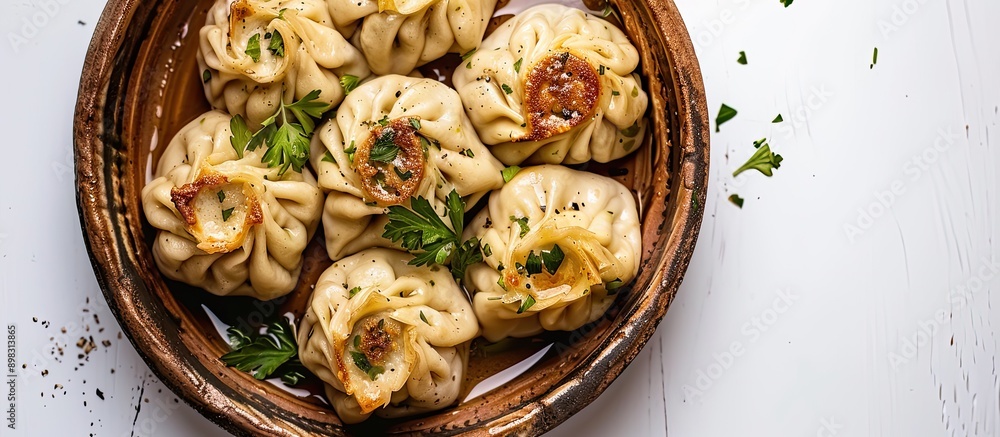 Poster beef and lamb khinkali dumplings presented on a rustic plate with herbs against a white backdrop pro