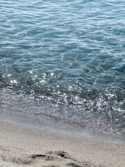 Reflections of the sun on the water on the seashore.