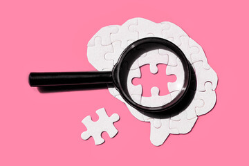 Brain Puzzle with Magnifying Glass on Vibrant Pink Background