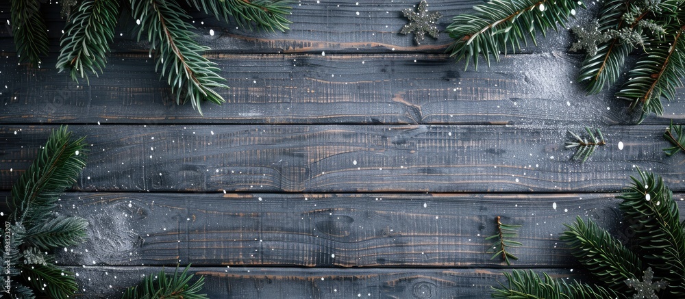 Fototapete Top view of a Christmas themed gray wooden background adorned with a fir tree providing a designated area for your design or text in the copy space image
