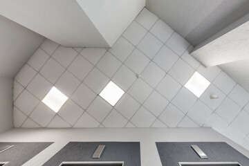 cassette stretched or suspended ceiling with square halogen spots lamps and drywall construction in...