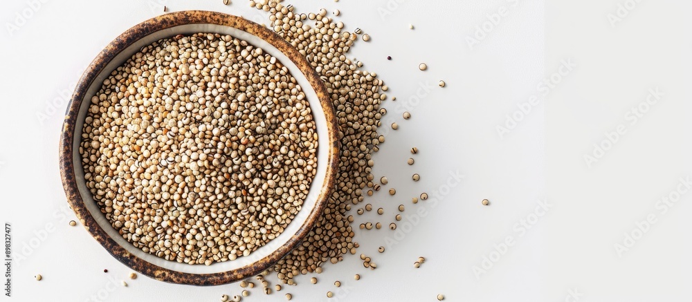 Poster chenopodium quinoa grains in a bowl with a white background suitable for use as a copy space image