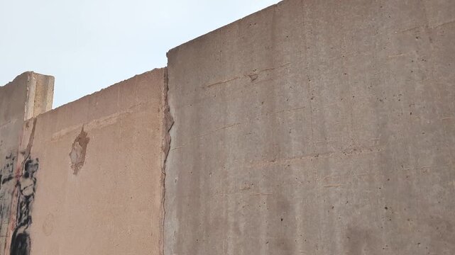 In motion, blockade wall POV. Concept of immigration, borders, war, and conflict