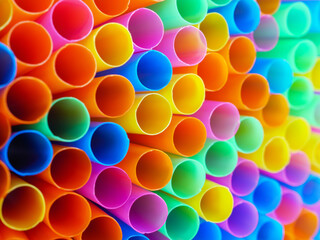 Abstract beautiful multicolored drinking straws, macro rainbow circle of tube background
