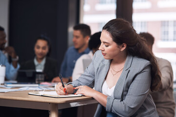 Business woman, writing and meeting with ideas, writer planning and article inspiration in boardroom. Employee, notebook and notes for professional job at news publication office with staff at desk