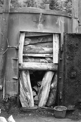retort filled with wood and ready to burn out charcoal, black and white photo, Szczerbanówka, Bieszczady Mountains