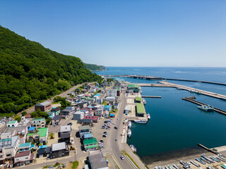 Naklejka premium Rausu, Hokkaido: Aerial drone view of the Rausu town and harbor in the Shiretoko peninsula in Hokkaido in summer in Japan