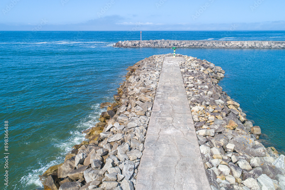 Aufkleber view of the breakwater of a harbor on a summer day with calm seas