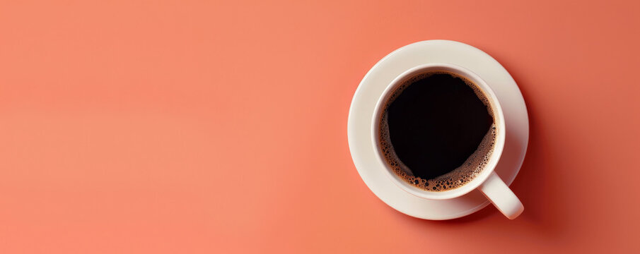 Mockup. Hot black coffee on a light coral background, providing a lively and vibrant look with space for text or graphics.