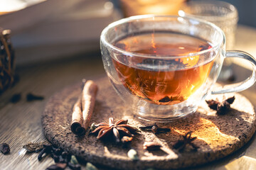 Fragrant hot tea with cinnamon on a wooden table