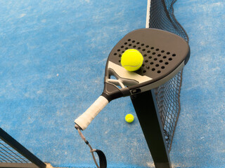 Paddle tennis still life. Racket, balls and turf