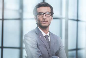Fototapeta premium Dedicated to his business. Shot businessman standing with his arms crossed crossed in an office at work.