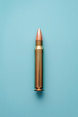 Bullet isolated on pastel blue background minimalistic firearm concept sleek metallic object against soft color contrast weapon imagery in modern design neutral backdrop clean and simple aesthetic