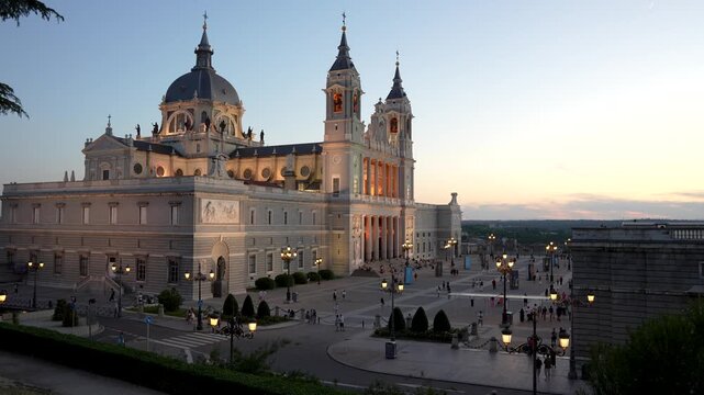 Almudena Cathedral Sunset in Madrid Spain Crowds Golden Light at Dusk Famous Landmark Near Royal Palace