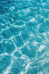 Obraz premium A serene and clear blue swimming pool, with gentle ripples reflecting the sun.