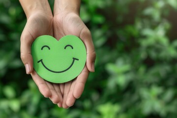 Green, leafy plants behind hands holding green hearts with smiling faces