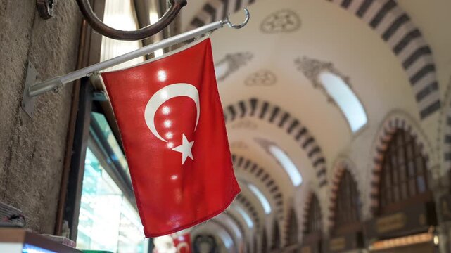 Close up of the small national flag of Turkey on the wall in the Spice Bazaar or Egyptian Bazaar. Things to do and buy souvenirs In Istanbul