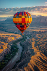 Obraz premium An awe-inspiring view of a single brightly colored hot air balloon ascending into the clear turquoise Albuquerque sky set against a stunning desert landscape at sunrise