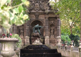 View of the Medici fountain at the Luxembourg Garden at sunset in Paris, France