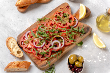 Tomatoes salad  with pesto sauce and arugula summer healthy eating salad