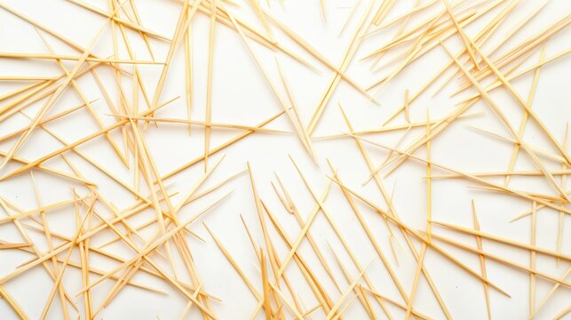 Many wooden toothpicks spread on a white background Background for design