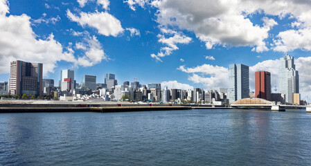 Tokyo city skyline, waterfront skyscrapers against blue sky, Japan capital cityscape