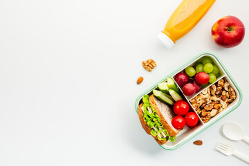 Healthy lunchbox with fresh sandwich, fruits and nuts. Ideal for nutrition blogs and wellness sites. Perfect to promote balanced diet and meal preparation
