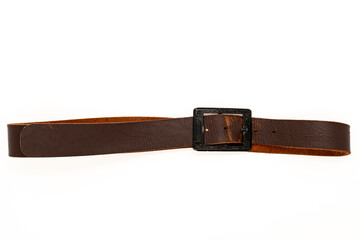 Worn Men's leather belt in a dark brown color with a metal buckle on white background. Top view or...