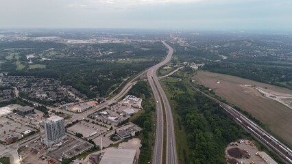 Aerial view of a highway running through a suburban area on a sunny day in Waterloo, Ontario, Canada