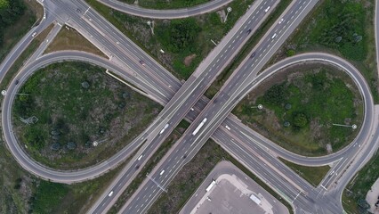 Aerial view of a highway interchange with looping roads and green spaces in Cambridge, Canada