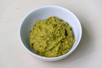 Potol vorta in a white ceramic bowl on wooden surface. Bhorta is the simplest and traditional food from Bangladesh and the Bengal region of India.