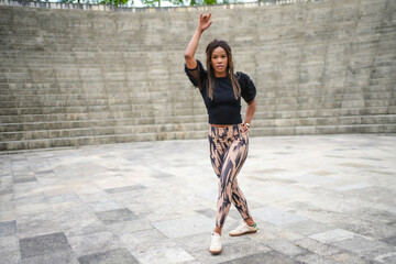 Latin woman having fun dancing cuban salsa in a park