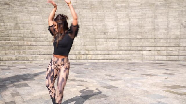 Latin beauty woman dancing sensually cuban salsa in a park