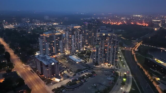 Aerial footage of the Barrel Yards apartment complex illuminated at dusk in Waterloo, Canada