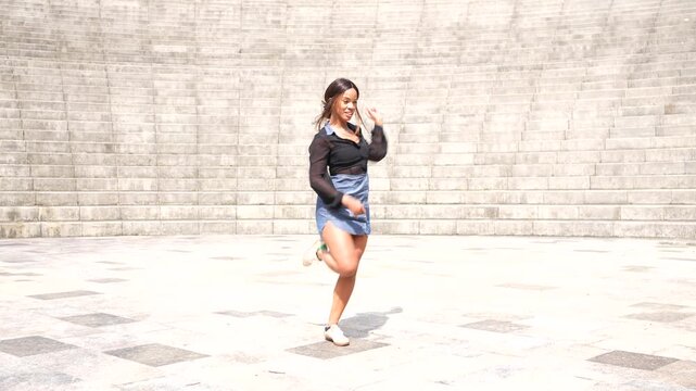 Latin beauty woman gesturing gentile dancing salsa in a park