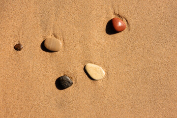 Five stones, placed neatly by the water of Lake Michigan, adorn the beach at Kohler-Andrae State Park, Sheyboygan, Wisconsin