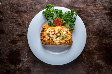 Seafood Lasagne with shrimp, prawn, tomato and coriander served in plate isolated table side view of italian food