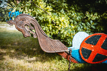 Viking dragon boat decoration with shield and chain, showing craftsmanship and historical importance
