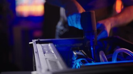 Person cleaning dust inside gaming computer with vacuum cleaner 4K