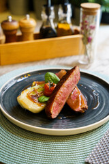 Grilled duck breast filet with cabbage and tomato