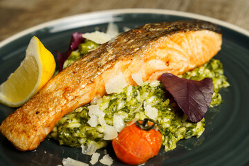 Fried salmon with lemon, asparagus, broccoli, scallions