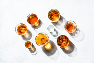 Strong alcohol drink. Cognac, whisky, rum, tequila at white background. Top view.