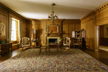 Chicago, IL, USA - June 19, 2019: Interior and miniature of table and chairs on carpet against fireplace in the room of a house at Chicago Art Museum
