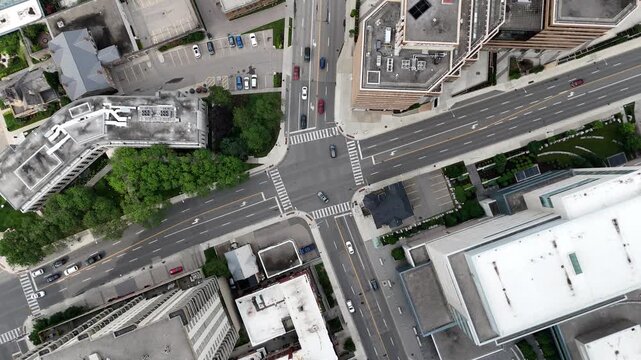 Rotating aerial footage of the traffic in an urban suburban area in Waterloo City, Ontario, Canada