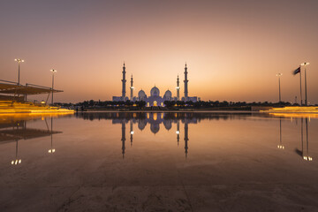 View of Grand Mosque in Abu Dhabi during very nice sunset. Beautifull warm colors on the sky.